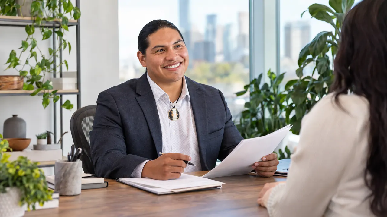 Man, the staffing agency recruiter, proudly at work in a bright modern office, the work itself beautiful and in sharp focus